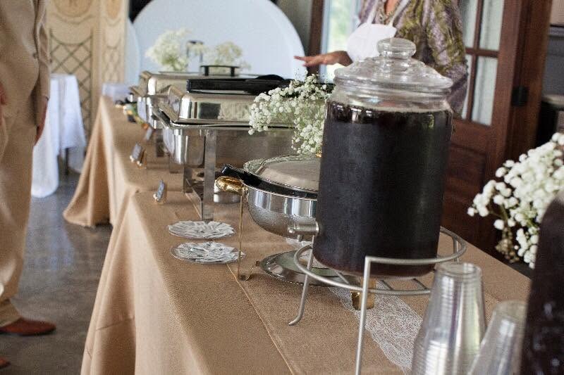 Buffet and beverage station styled with baby’s breath and neutral linens