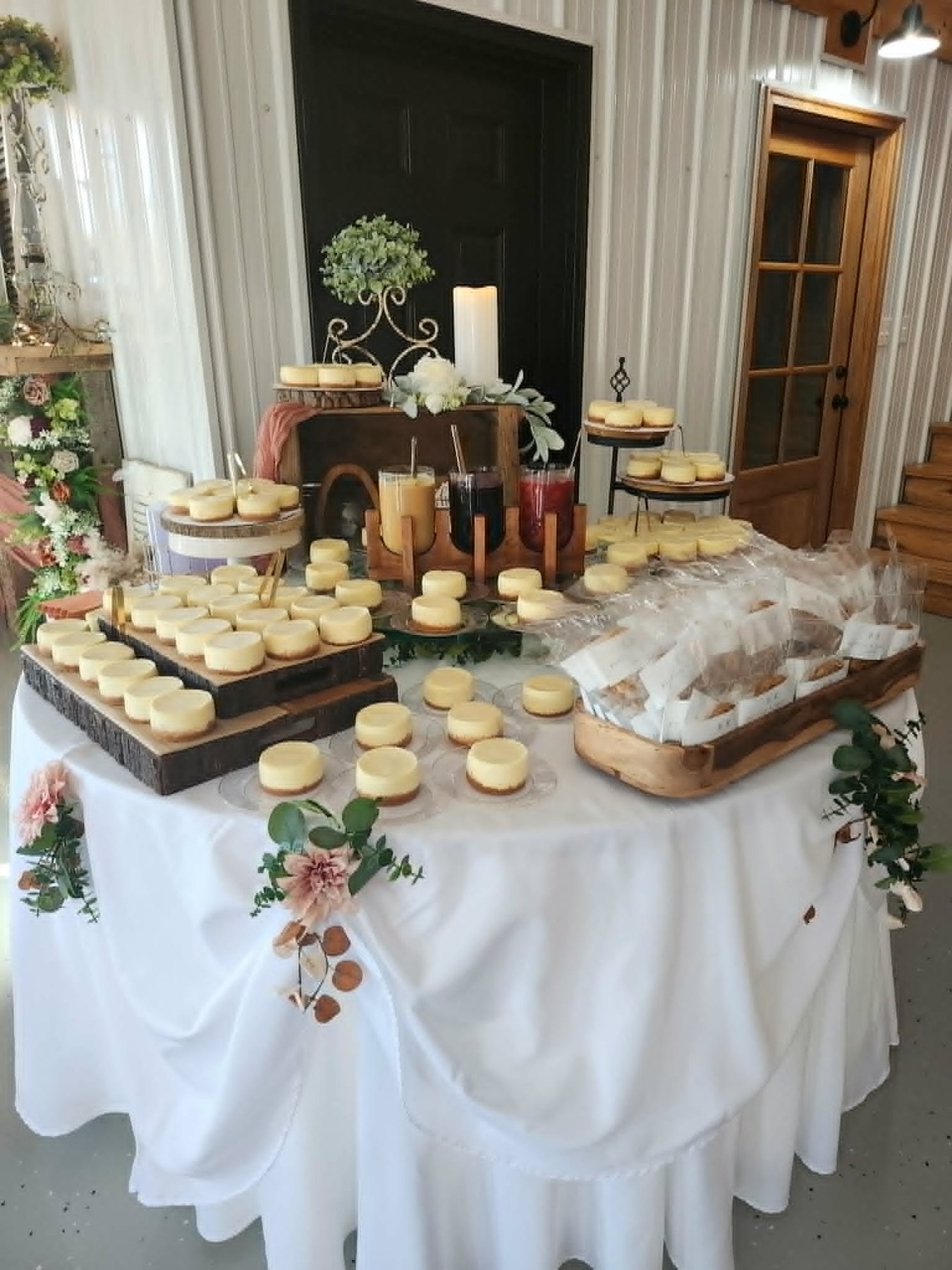 Decorated dessert table with individual cheesecakes and beverages