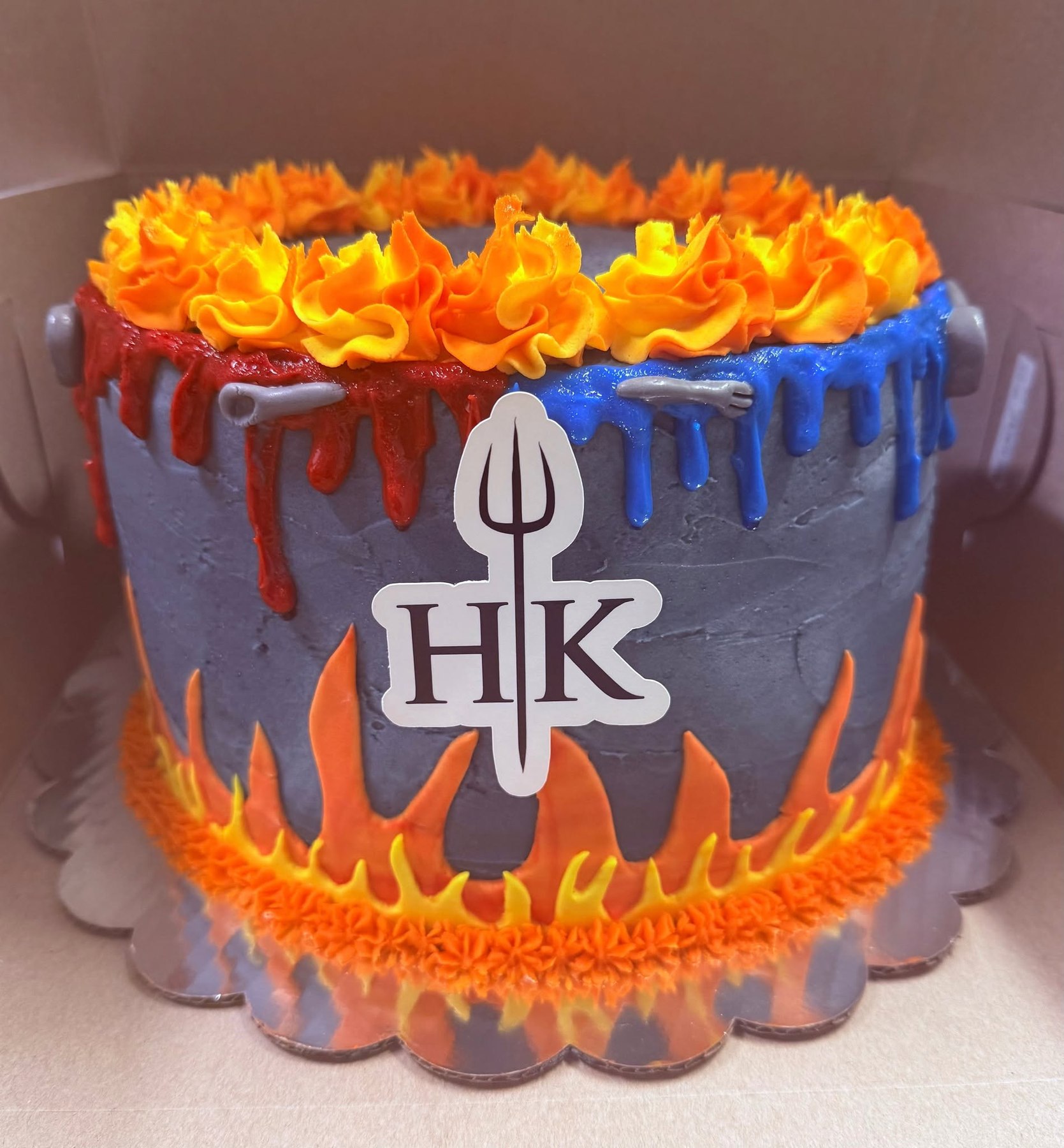 Gray celebration cake with dramatic orange flame details