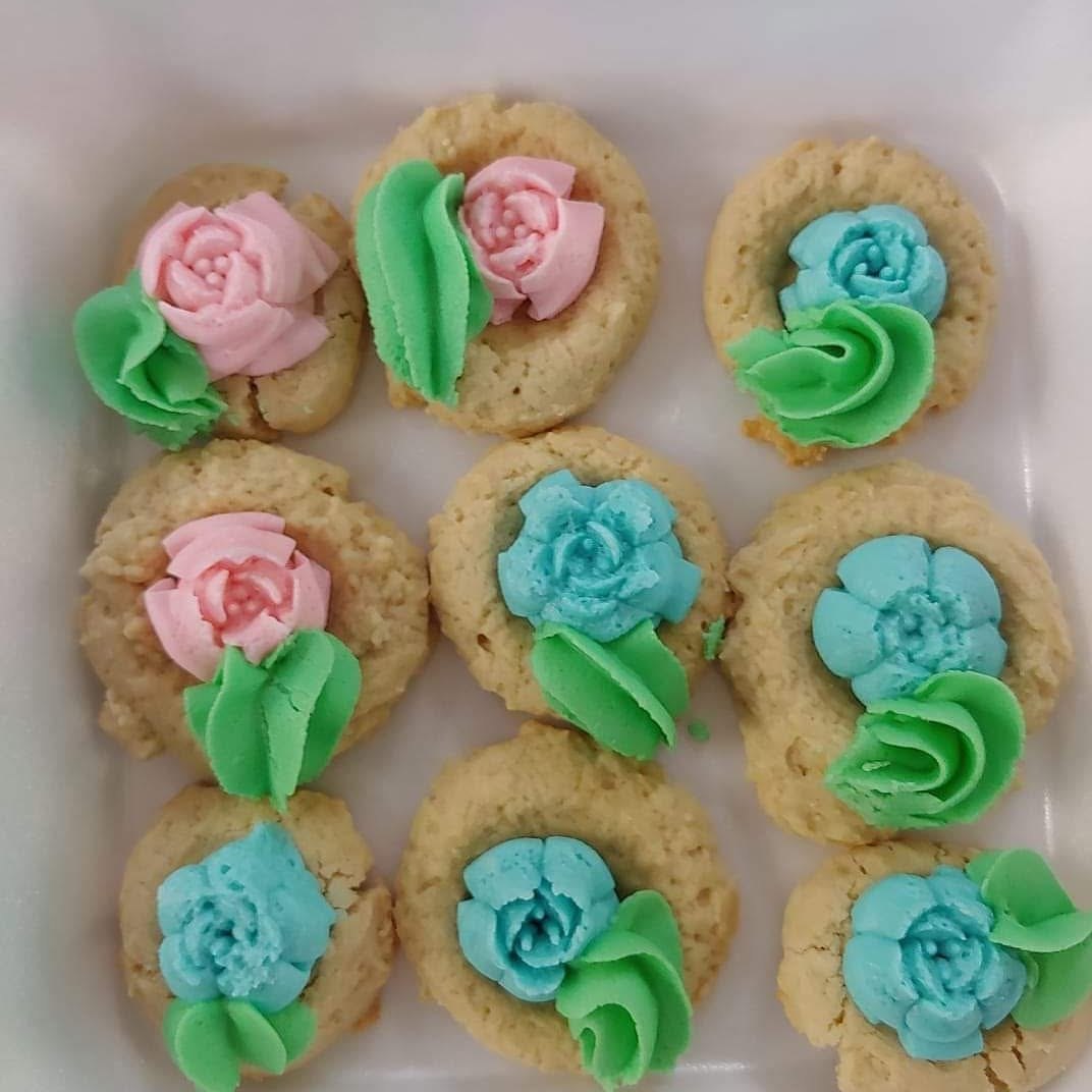 Cookies decorated with colorful buttercream flowers
