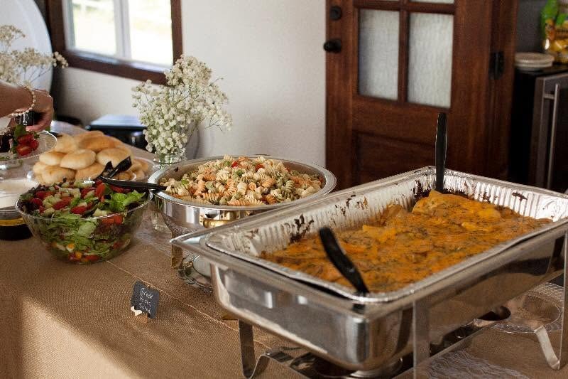 Buffet with pasta salad, baked entrée, green salad, and fresh rolls