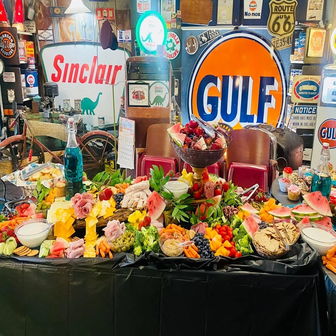 Abundant grazing table with meats, cheeses, fruit, vegetables, crackers, and desserts
